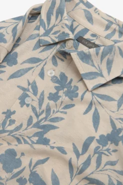 Polo in piquet fantasia fiore celeste
